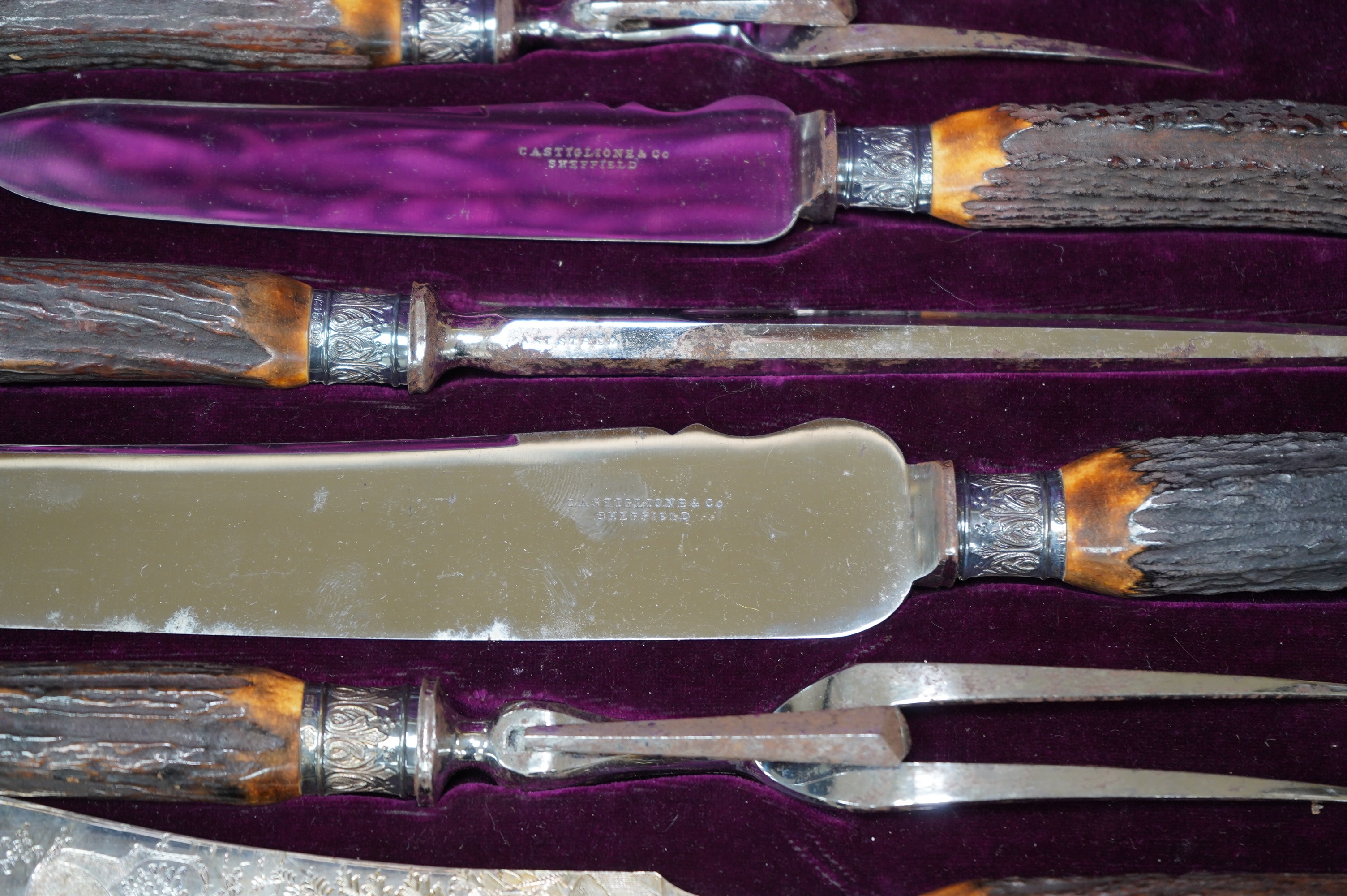 A gilt tooled leather cased stag handled silver collared carving set, case 44cm wide. Condition - good